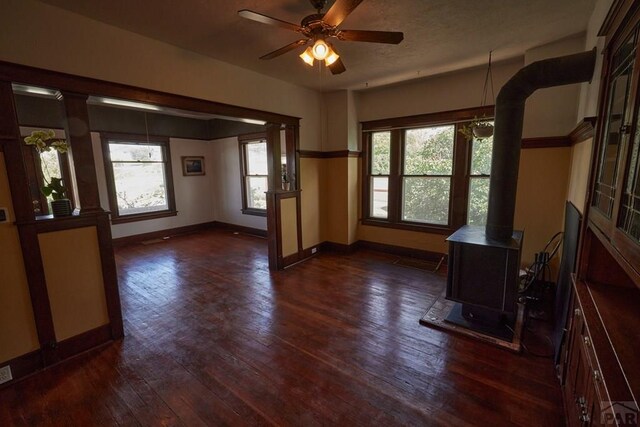 315 S Oak St, Trinidad, CO 81082 - unfurnished office featuring baseboards, dark wood finished floors, a wood stove, and a ceiling fan