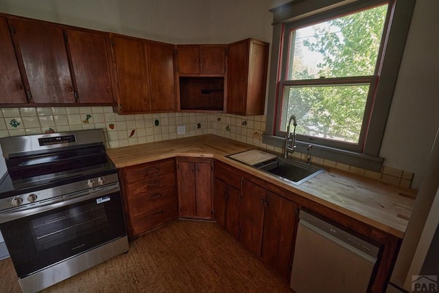 315 S Oak St, Trinidad, CO 81082 - kitchen with stainless steel appliances, a sink, decorative backsplash, wood counters, and plenty of natural light