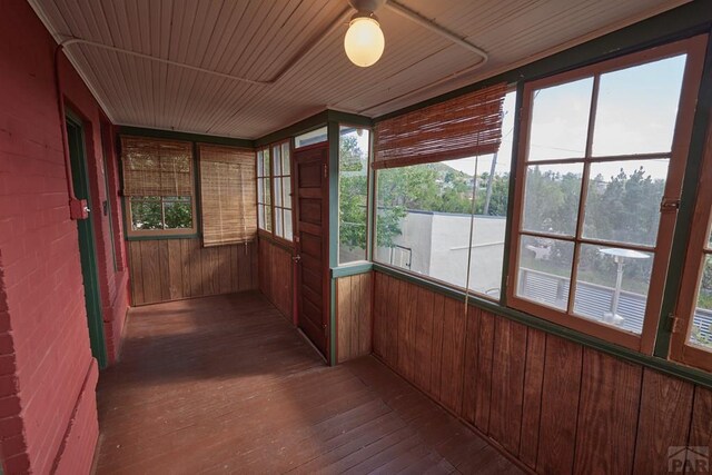 315 S Oak St, Trinidad, CO 81082 - unfurnished sunroom featuring hardwood / wood-style flooring and wooden walls