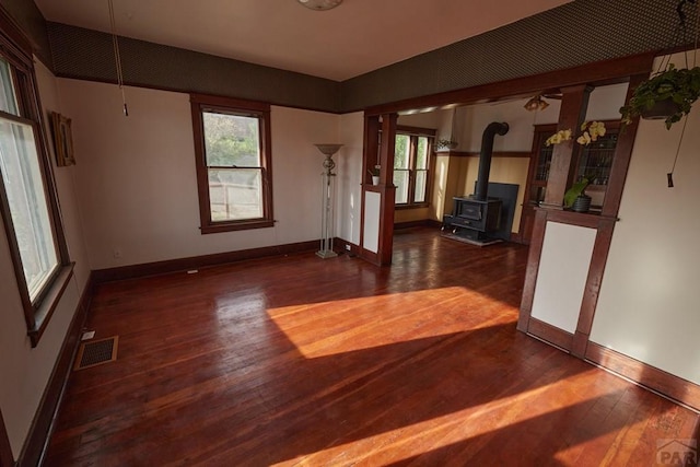315 S Oak St, Trinidad, CO 81082 - spare room featuring a wood stove, hardwood / wood-style floors, plenty of natural light, and baseboards