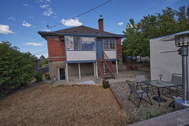 315 S Oak St, Trinidad, CO 81082 - rear view of property with a patio area, stairs, a chimney, roof with shingles, and brick siding