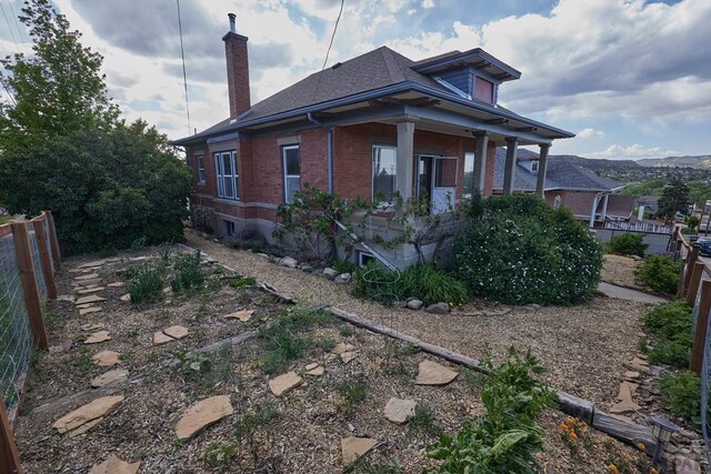 315 S Oak St, Trinidad, CO 81082 - view of front of property with a chimney, brick siding, and roof with shingles