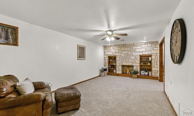 4321 Goodnight Ave, Pueblo, CO 81005 - carpeted living area featuring a fireplace, a ceiling fan, and baseboards
