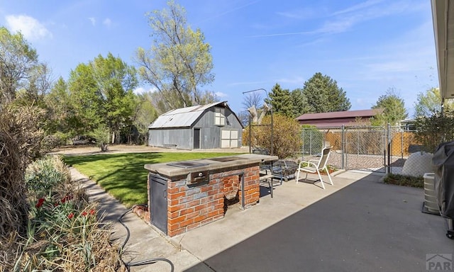 4321 Goodnight Ave, Pueblo, CO 81005 - view of patio / terrace featuring fence, an outdoor fire pit, an outbuilding, and a storage unit