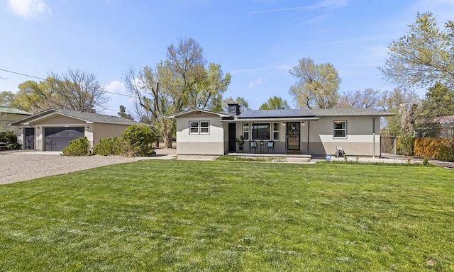4321 Goodnight Ave, Pueblo, CO 81005 - single story home featuring solar panels, gravel driveway, a front yard, and fence