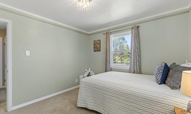 4321 Goodnight Ave, Pueblo, CO 81005 - bedroom featuring baseboards, a chandelier, and carpet