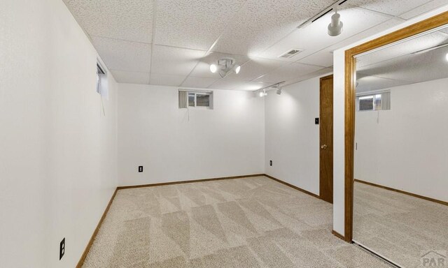 4321 Goodnight Ave, Pueblo, CO 81005 - finished basement with carpet floors, visible vents, a drop ceiling, and baseboards