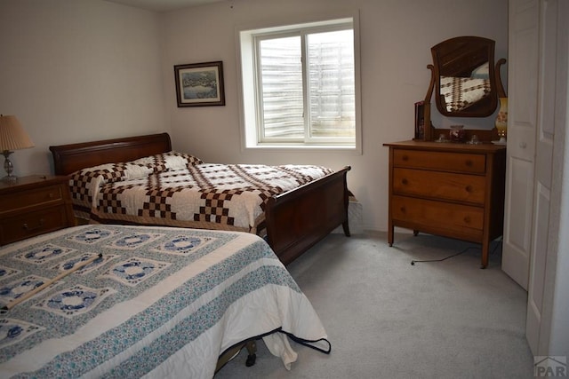 bedroom featuring light carpet