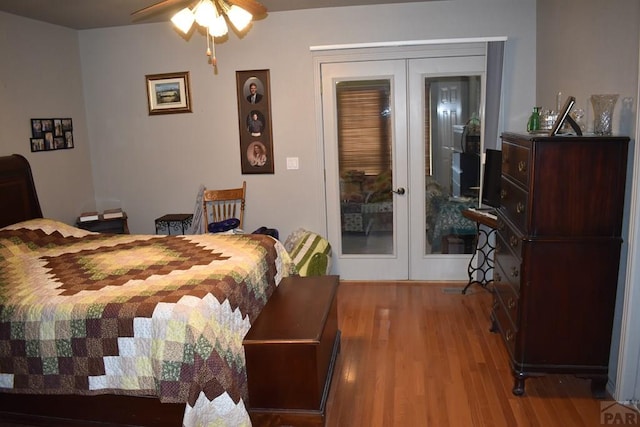 bedroom featuring wood finished floors and french doors