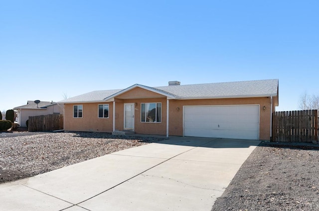 single story home featuring driveway, an attached garage, fence, and stucco siding