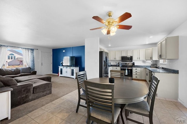 dining space featuring light tile patterned floors, baseboards, a ceiling fan, light colored carpet, and recessed lighting