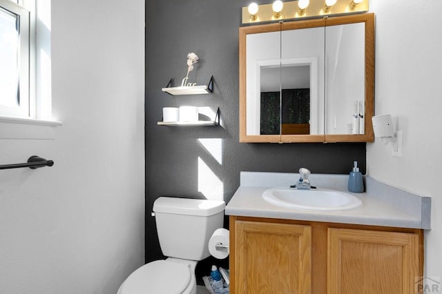 half bathroom with toilet and vanity