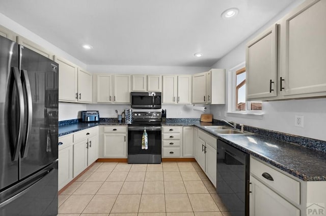 kitchen with recessed lighting, a sink, black appliances, and light tile patterned floors