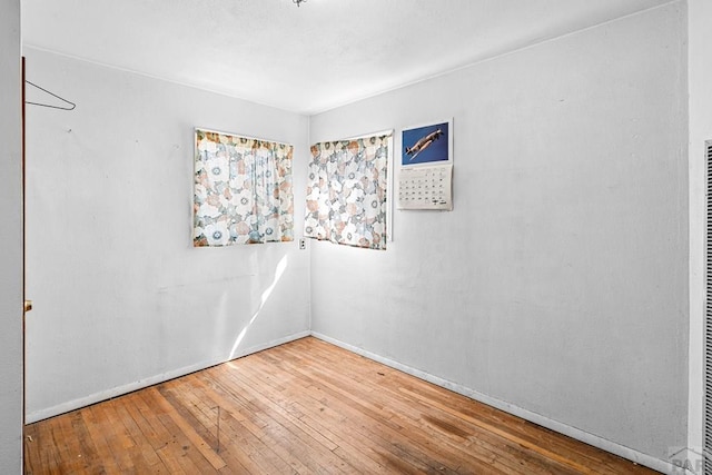 empty room with wood-type flooring