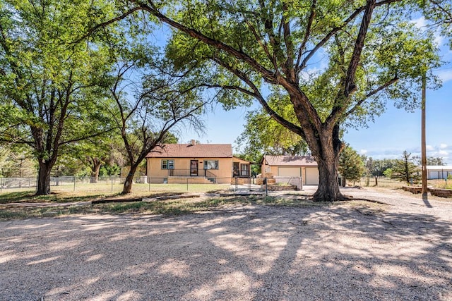 single story home with a fenced front yard, a garage, and stucco siding