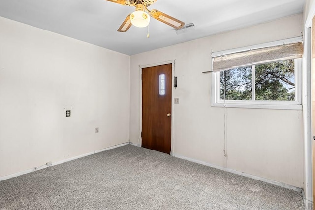 interior space with a ceiling fan and baseboards