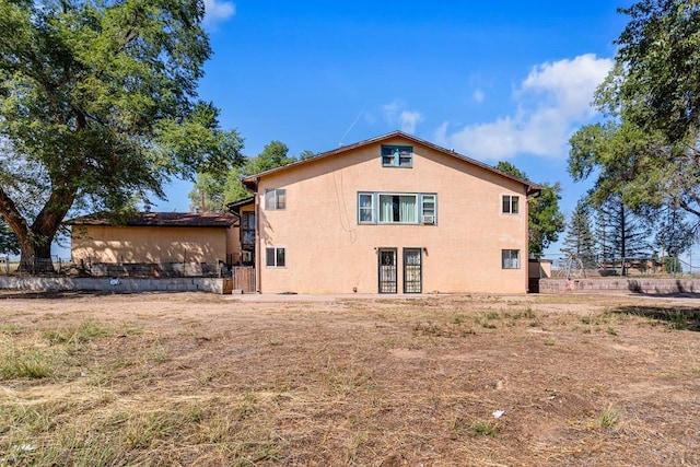 back of property featuring stucco siding