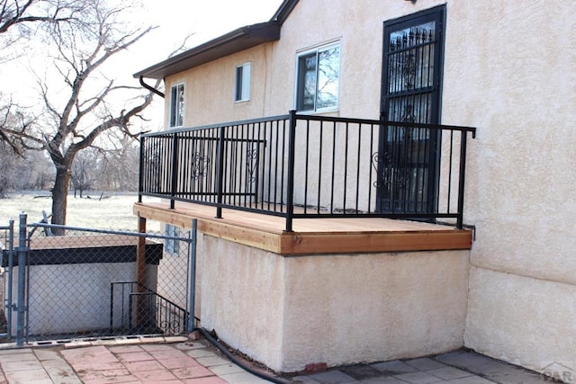 view of home's exterior featuring a gate, fence, and stucco siding