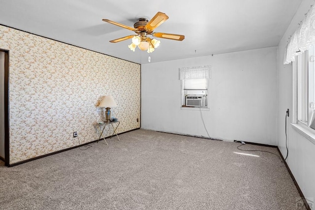 empty room featuring carpet, ceiling fan, cooling unit, baseboards, and wallpapered walls