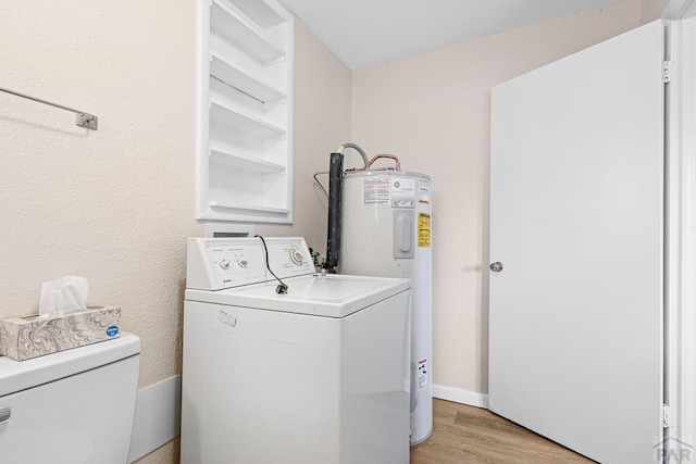 laundry room featuring laundry area, baseboards, washer / clothes dryer, light wood-style floors, and water heater