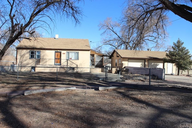 view of front facade featuring a fenced front yard and stucco siding