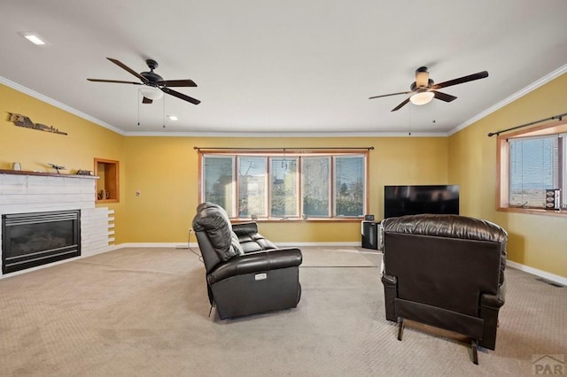 living area featuring a glass covered fireplace, light colored carpet, crown molding, and baseboards