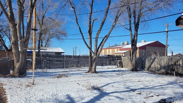 yard covered in snow with fence