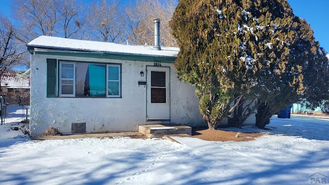 view of front of home featuring fence and stucco siding