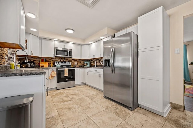 40 Macalester Rd, Pueblo, CO 81001 - kitchen with appliances with stainless steel finishes, decorative backsplash, white cabinets, a sink, and recessed lighting