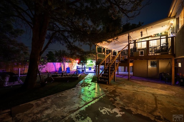 40 Macalester Rd, Pueblo, CO 81001 - patio at night featuring stairs, fence, and a wooden deck