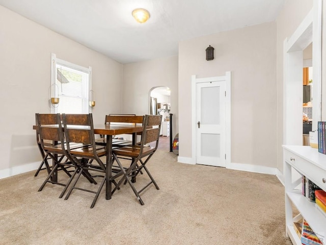 309 Quincy St, Pueblo, CO 81004 - dining area featuring arched walkways, carpet flooring, and baseboards