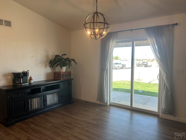 dining room with baseboards, a notable chandelier, dark wood-style floors, and visible vents