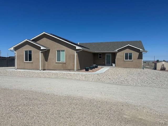 ranch-style house featuring stucco siding