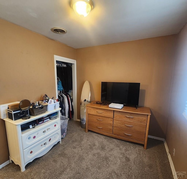 carpeted bedroom featuring a closet, visible vents, and baseboards