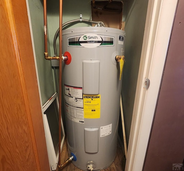 utility room featuring water heater