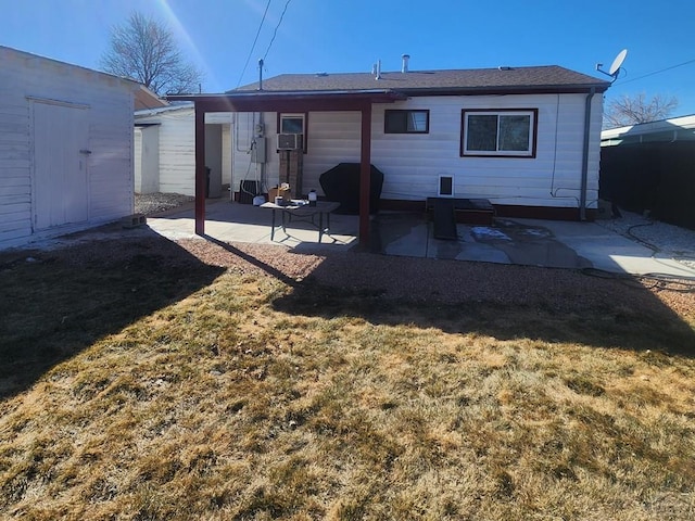 rear view of house with a yard and a patio