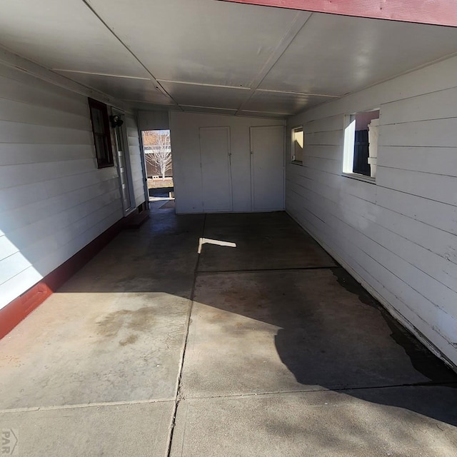 garage featuring wood walls