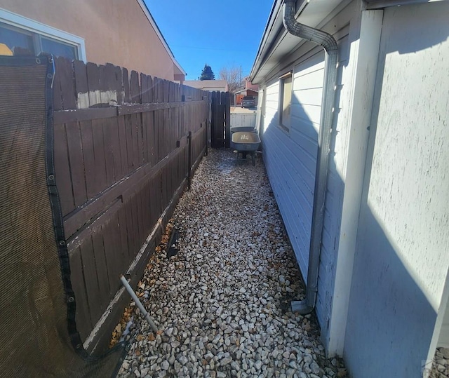 view of side of property featuring fence