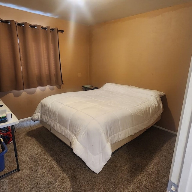 carpeted bedroom with baseboards