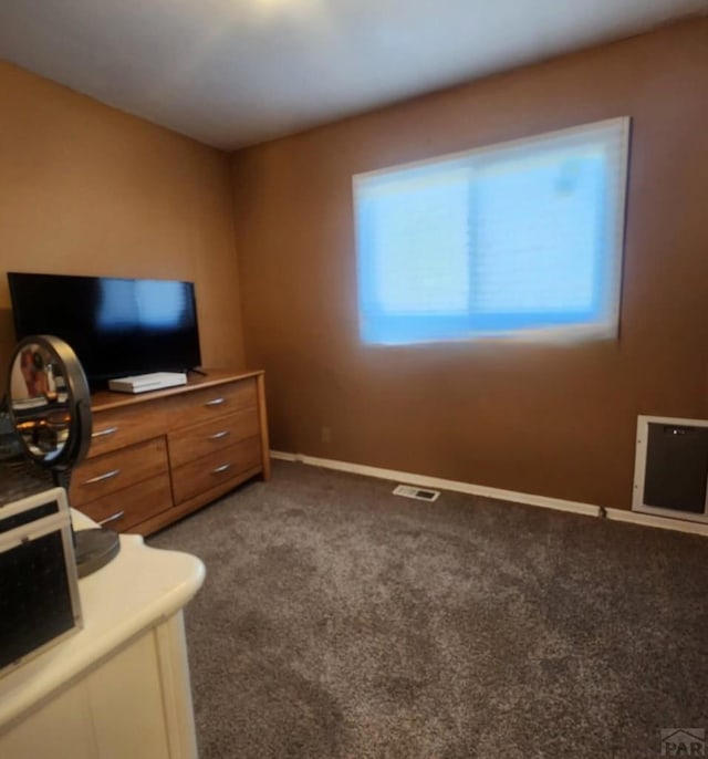 unfurnished bedroom with carpet flooring, visible vents, and baseboards