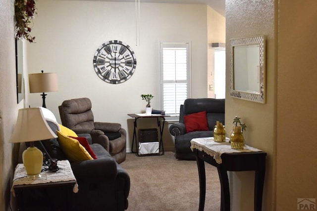 living area featuring light carpet