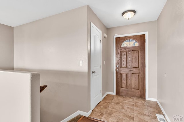 foyer with visible vents and baseboards