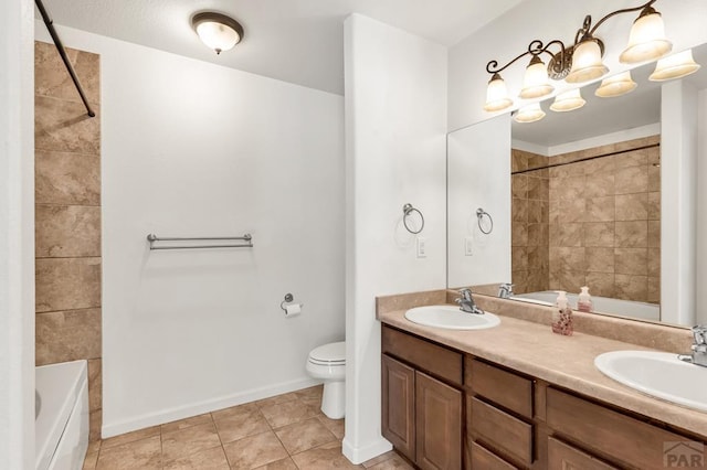 full bath featuring double vanity, a sink, toilet, and tile patterned floors