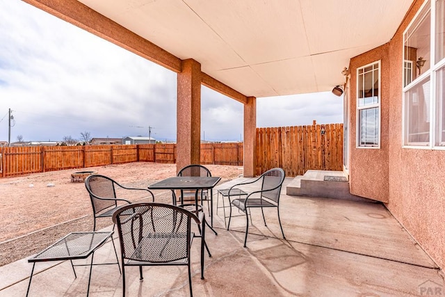 view of patio featuring outdoor dining area and a fenced backyard