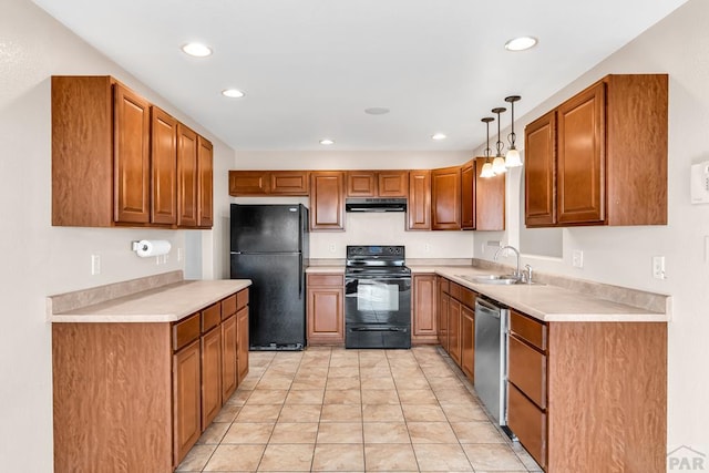 kitchen featuring brown cabinetry, a sink, under cabinet range hood, and black appliances