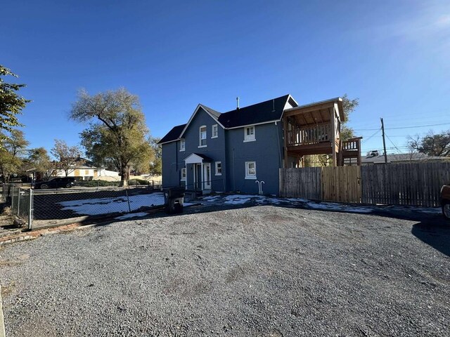 back of house featuring fence