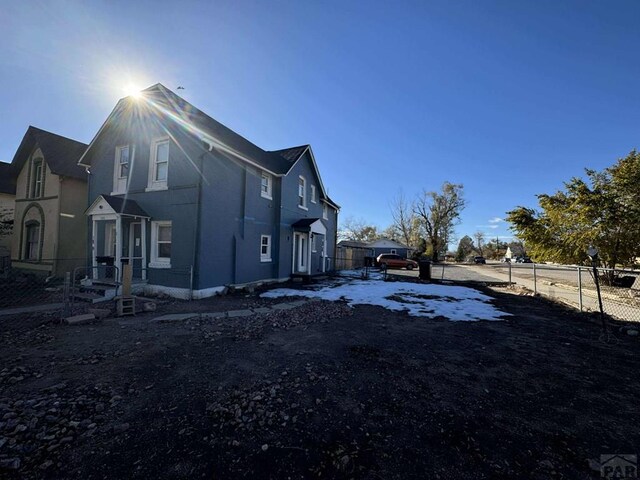 view of side of home featuring fence