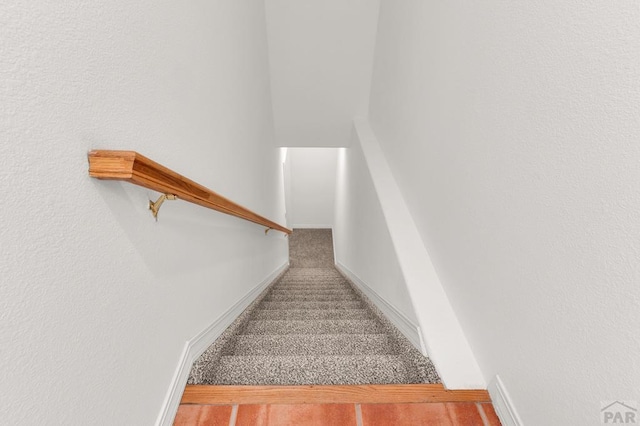 stairway featuring carpet floors and baseboards