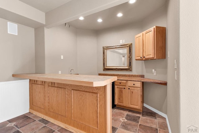 kitchen featuring recessed lighting, light countertops, light brown cabinetry, a peninsula, and baseboards