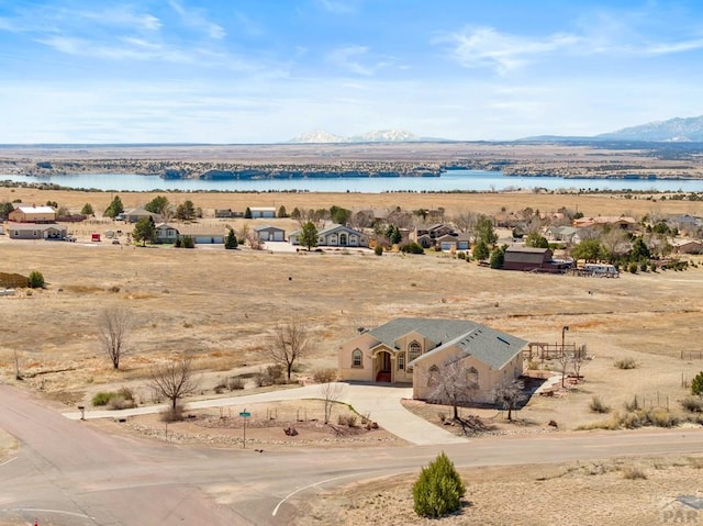 birds eye view of property featuring a water and mountain view